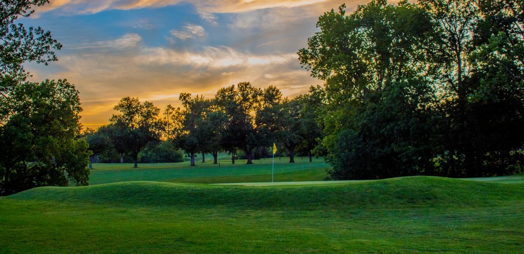 Golf Course with yellow pink and orange sky